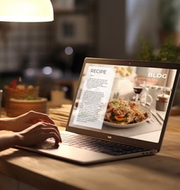 a woman writing a recipe blog in warm lighting