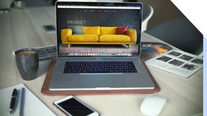 A laptop with a product page featuring a yellow sofa.
