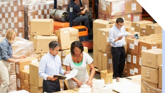 Team of people work together in an ecommerce warehouse to fulfill customer orders