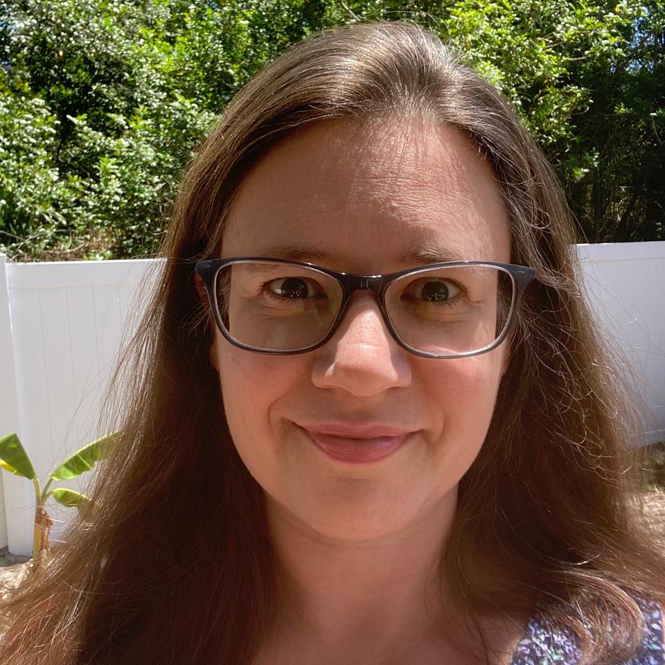 Smiling headshot of Michelle Kulas outside in the sun