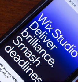 Screenshot of a mobile phone with Wix Studio's tagline on it 