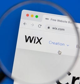 Magnifying glass inspecting the Wix homepage