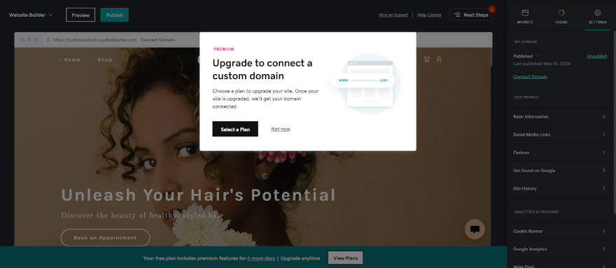 Screenshot of GoDaddy Pop-up notification to update plans to upload a custom domain to website.